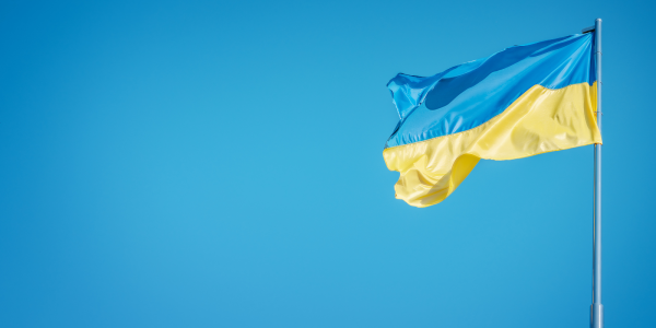 a blue sky with a Ukrainian flag blowing in the wind. a blue sky with a Ukrainian flag blowing in the wind.