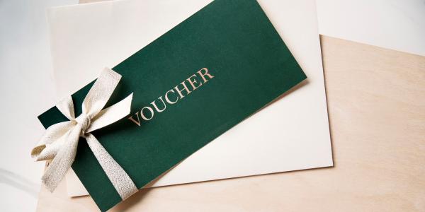 An envelope with the word 'VOUCHER' on the front in white text. An envelope with the word 'VOUCHER' on the front in white text.