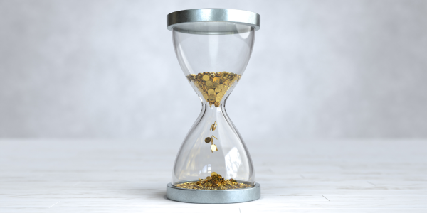 An hourglass but instead of being filled with sand it is filled with golden coins. An hourglass but instead of being filled with sand it is filled with golden coins.