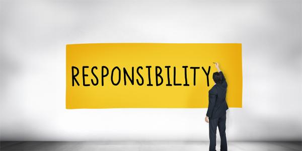 A grey background with a yellow banner, on the banner the word 'RESPONSIBILITY' can be seen being written in black ink by a person standing next to it. A grey background with a yellow banner, on the banner the word 'RESPONSIBILITY' can be seen being written in black ink by a person standing next to it.