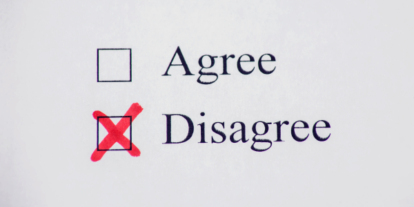 Typed words in black ink on paper 'AGREE', 'DISAGREE' next to each word is a check box. The box against the word 'DISAGREE' is checked with a red cross. Typed words in black ink on paper 'AGREE', 'DISAGREE' next to each word is a check box. The box against the word 'DISAGREE' is checked with a red cross.