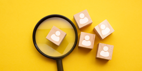 5 wooden blocks, one is being looked at through a magnifying glass. 5 wooden blocks, one is being looked at through a magnifying glass.