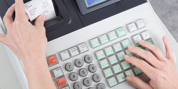 A till printing a receipt. A till printing a receipt.