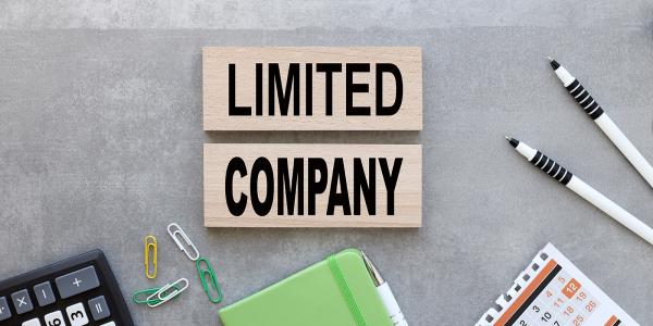 Various stationary scattered on a desk with the words 'LIMITED COMPANY' in the centre. Various stationary scattered on a desk with the words 'LIMITED COMPANY' in the centre.