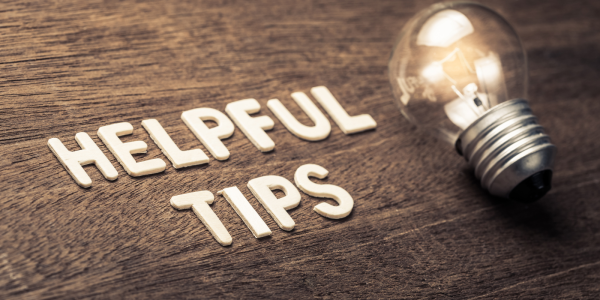 A wooden table with light coloured wooden letters spelling out the words 'HELPFUL TIPS' next to a lightbulb. A wooden table with light coloured wooden letters spelling out the words 'HELPFUL TIPS' next to a lightbulb.
