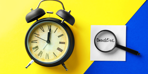 Yellow and blue background with a clock and a magnifying glass hovering over the word 'DEADLINE'. Yellow and blue background with a clock and a magnifying glass hovering over the word 'DEADLINE'.