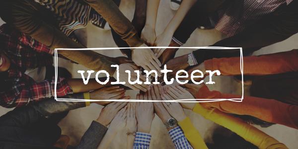 various hands reaching into the centre with an overlay of the word 'VOLUNTEER' visible. various hands reaching into the centre with an overlay of the word 'VOLUNTEER' visible.