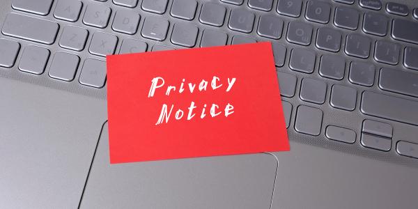 A keyboard with a red sticky note attached, the note reads 'PRIVACY NOTICE'. A keyboard with a red sticky note attached, the note reads 'PRIVACY NOTICE'.