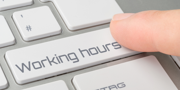 a keyboard with a key saying 'WORKING HOURS' a keyboard with a key saying 'WORKING HOURS'