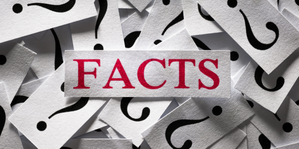 Lots of pieces of paper with question marks printed on them all bundled in a pile, on the top of the pile is a larger piece of paper with the word 'FACTS' on it in red text. Lots of pieces of paper with question marks printed on them all bundled in a pile, on the top of the pile is a larger piece of paper with the word 'FACTS' on it in red text.