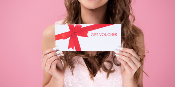 A person holding a voucher in their hands. A person holding a voucher in their hands.
