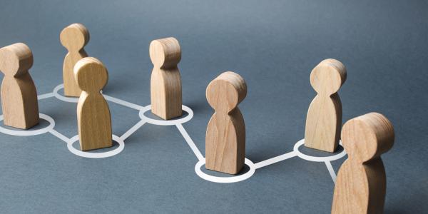 7 wooden figures each has a white circle around it, all circles are interlinked with a white line from one to another. 7 wooden figures each has a white circle around it, all circles are interlinked with a white line from one to another.