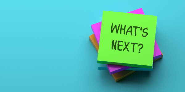 Pile of post it notes, the top note reads 'WHATS NEXT?' Pile of post it notes, the top note reads 'WHATS NEXT?'