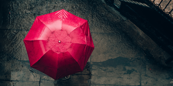 A dark street with a red umbrella. A dark street with a red umbrella.