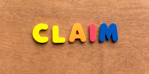 small colourful plastic letters arranged to spell out the word 'CLAIM' against a wooden background. small colourful plastic letters arranged to spell out the word 'CLAIM' against a wooden background.