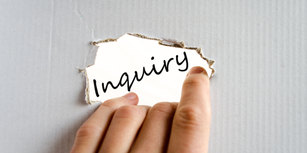 a sheet of cardboard with a hole in the centre, through the hole the word 'INQUIRY' can be seen. a sheet of cardboard with a hole in the centre, through the hole the word 'INQUIRY' can be seen.