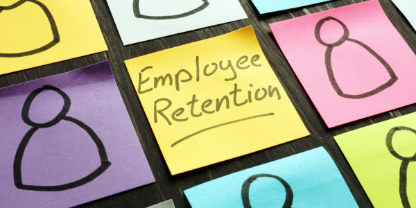 A bunch of colourful post it notes each with a person drawn on them, the middle one says the words 'EMPLOYEE RETENTION' A bunch of colourful post it notes each with a person drawn on them, the middle one says the words 'EMPLOYEE RETENTION'
