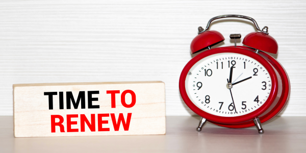 A red clock next to a sign that says 'TIME TO RENEW' A red clock next to a sign that says 'TIME TO RENEW'