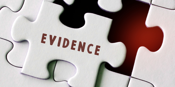 a white jigsaw missing one piece, the missing piece has the word 'EVIDENCE' on it. a white jigsaw missing one piece, the missing piece has the word 'EVIDENCE' on it.