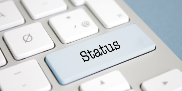 a keyboard, one key has the word 'STATUS' on it a keyboard, one key has the word 'STATUS' on it