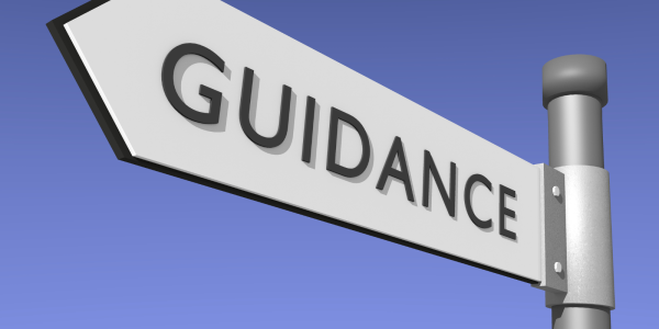 a white street sign with the word 'GUIDANCE' on it in black text a white street sign with the word 'GUIDANCE' on it in black text