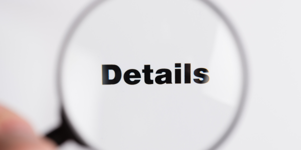 A magnifying glass hovering over the word 'DETAILS' A magnifying glass hovering over the word 'DETAILS'