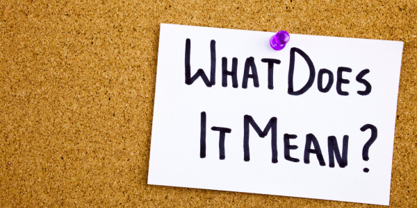 A pin board with a sheet of paper pinned to it, the paper reads 'WHAT DOES IT MEAN?' A pin board with a sheet of paper pinned to it, the paper reads 'WHAT DOES IT MEAN?'