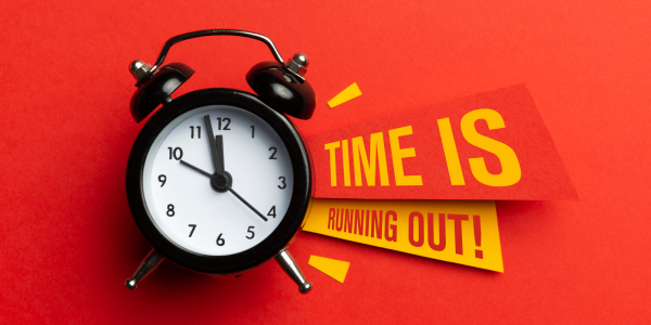 clock with the words 'TIME IS RUNNING OUT' next to it against a red background.
