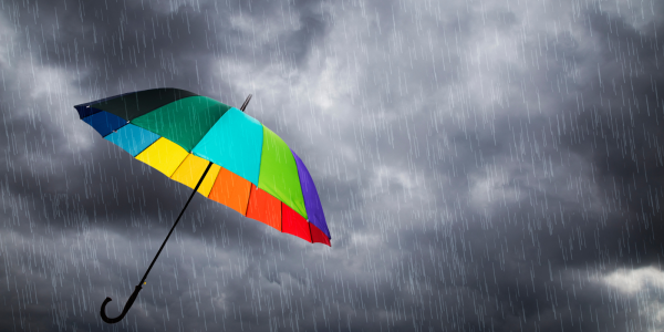a grey sky with a colourful umbrella a grey sky with a colourful umbrella