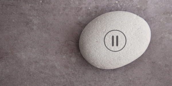 A stone with a pause button stamped onto it. A stone with a pause button stamped onto it.