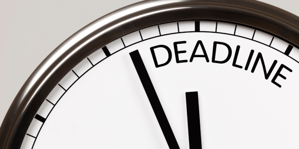 A wall clock with no numbers but instead the word 'DEADLINE' A wall clock with no numbers but instead the word 'DEADLINE'