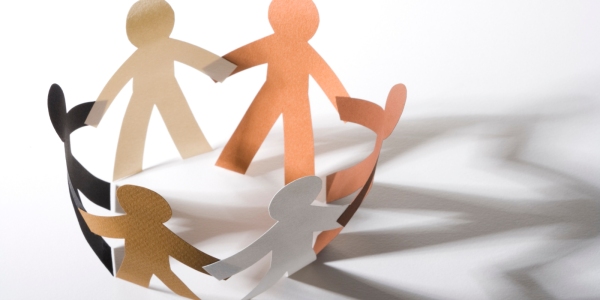 paper figures standing in a circle holding hands. paper figures standing in a circle holding hands.