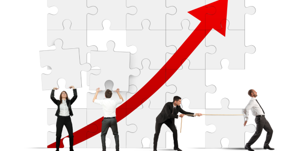 4 people fitting together a jigsaw on a wall of a red arrow increasing. 4 people fitting together a jigsaw on a wall of a red arrow increasing.