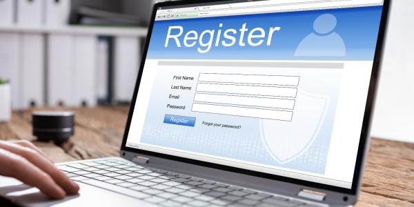 A laptop showing a registration screen. A laptop showing a registration screen.