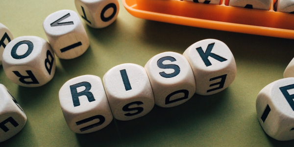 wooden cubes each containing a letter - together spells out the word 'RISK' wooden cubes each containing a letter - together spells out the word 'RISK'