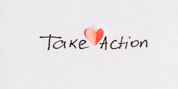 The words 'TAKE ACTION' handwritten in black ink with a red heart. The words 'TAKE ACTION' handwritten in black ink with a red heart.