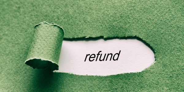 A green piece of paper with a tear in it revealing a white paper beneath, the white paper seen through the rip has the word 'REFUND' typed on it. A green piece of paper with a tear in it revealing a white paper beneath, the white paper seen through the rip has the word 'REFUND' typed on it.