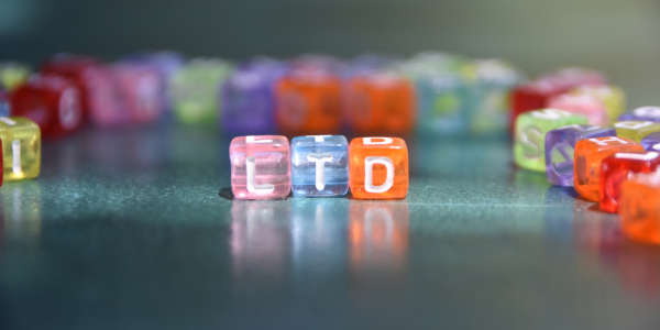 coloured square beads with letters on, the letters together spell out 'LTD' coloured square beads with letters on, the letters together spell out 'LTD'