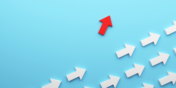 white arrows on a pale blue background with one red arrow pointing a different way. white arrows on a pale blue background with one red arrow pointing a different way.