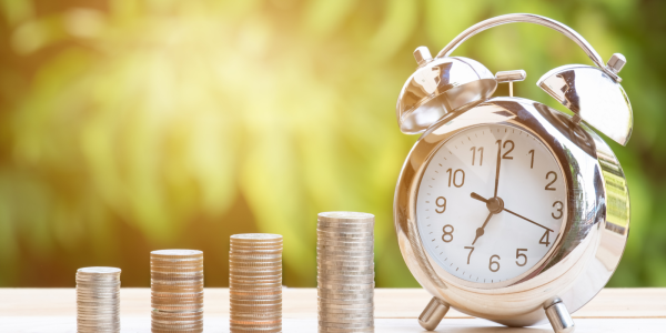 stacks of coins and a clock stacks of coins and a clock