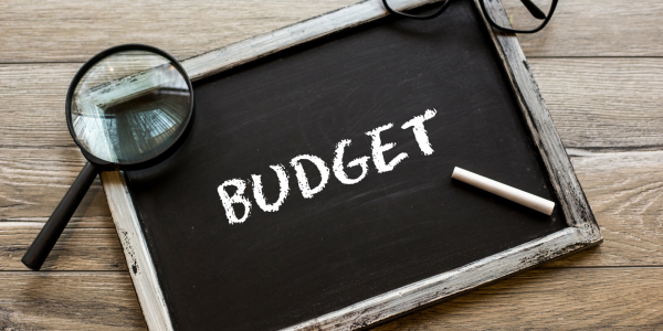 A chalkboard with the word 'BUDGET' written on it in white chalk A chalkboard with the word 'BUDGET' written on it in white chalk