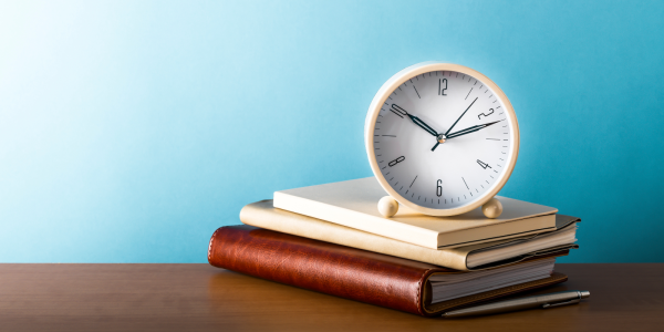 a stack of books with a clock on top a stack of books with a clock on top