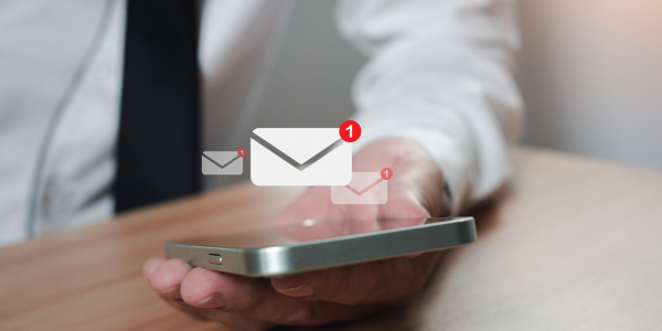 A person holding a smart phone with a message icon A person holding a smart phone with a message icon