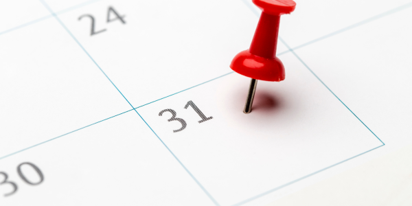 A calendar with a red pin pushed in the date box of the 31st A calendar with a red pin pushed in the date box of the 31st