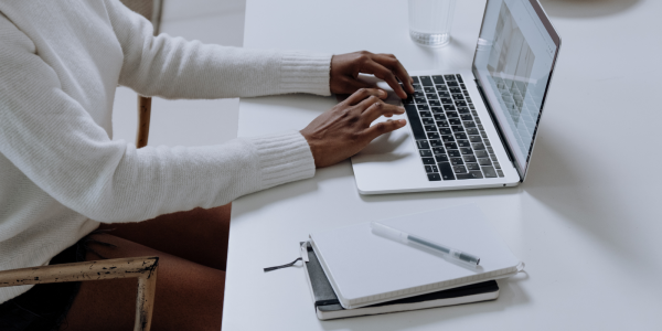 A person typing on a laptop A person typing on a laptop