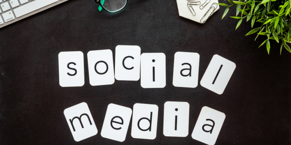 Black desk top with white card reading 'SOCIAL MEDIA' Black desk top with white card reading 'SOCIAL MEDIA'