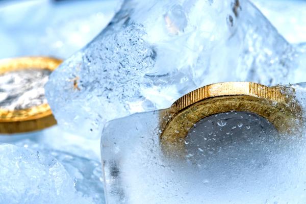 Frozen New British one pound sterling coin up close macro inside ice cubes Frozen New British one pound sterling coin up close macro inside ice cubes