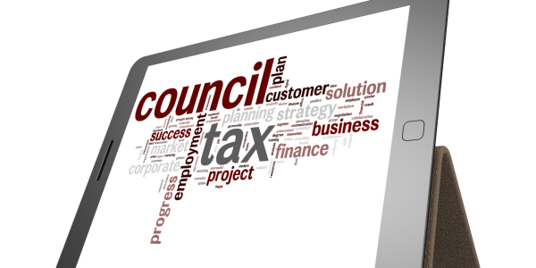 A tablet showing word art of the word 'COUNCIL TAX' surrounded by other associated words. 