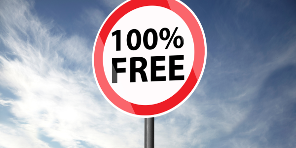 A red and white circular street sign with black text that reads '100% FREE'
