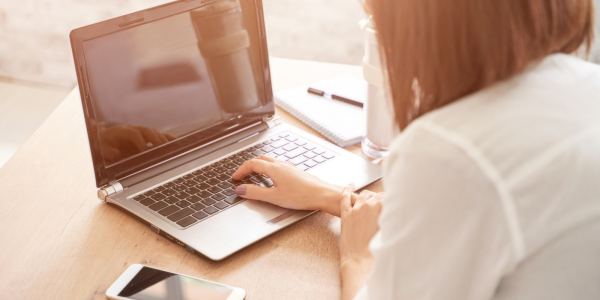 A person navigating a website on their laptop